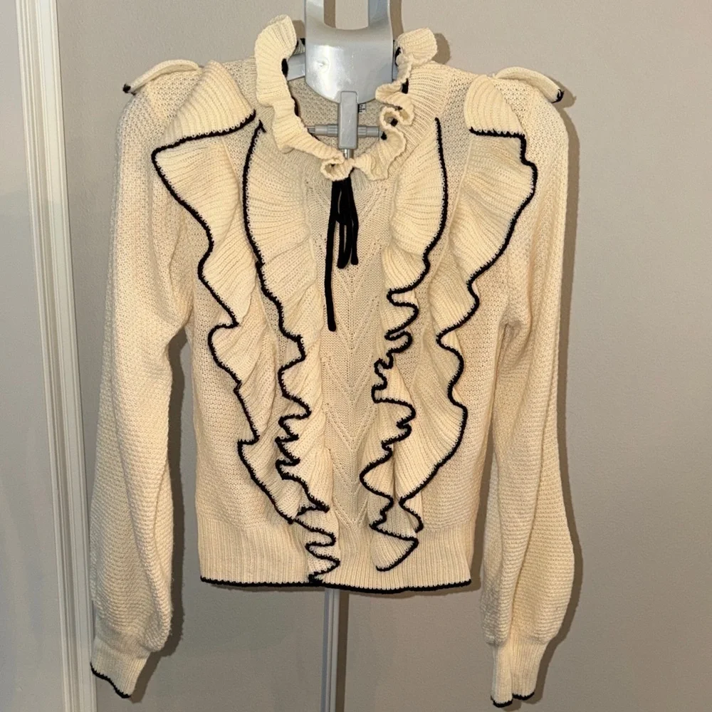 Stellah Ivory Sweater with Black Ruffle Accents